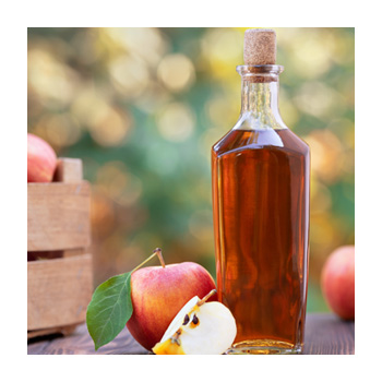 Image of apple cider vinegar in a bottle and an apple